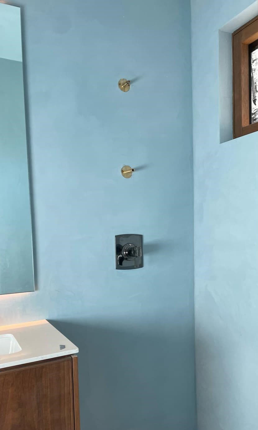 Picture of a bathroom wall that has been recently plastered and painted